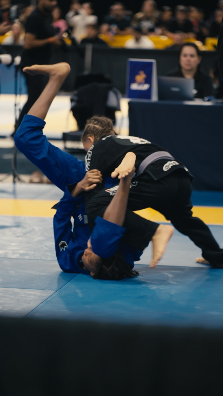 Young Brazilian jiu-jitsu competitors in an active match